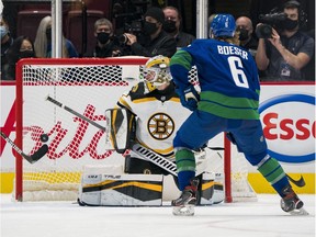 Vancouver Canucks forward Brock Boeser (6) scores on Boston Bruins goalie Jeremy Swayman (1) in the second period at Rogers Arena.