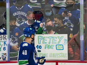 A young fan reacts after receiving a puck from Vancouver Canucks forward Elias Pettersson (40) prior to the start of a game against the Carolina Hurricanes at Rogers Arena.