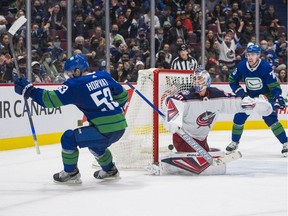 Vancouver Canucks forward Bo Horvat (53) scores the game winning goal on Columbus Blue Jackets goalie Elvis Merzlikins (90) in the third period at Rogers Arena. Vancouver Won 4-3.