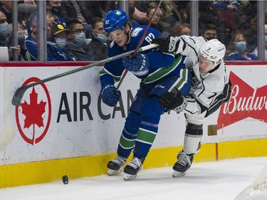 Dec 6, 2021; Vancouver, British Columbia, CAN; Los Angeles Kings defenseman Tobias Bjornfot (7) stick checks Vancouver Canucks forward Vasily Podkolzin (92) in the first period at Rogers Arena. Mandatory Credit: Bob Frid-USA TODAY Sports