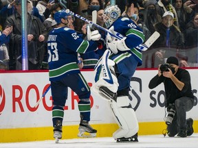 Canucks captain Bo Horvat, left, and goalie Thatcher Demko, celebrating Monday’s shutout victory over the L.A. Kings, are feeling a little better of late with four wins in their last five games.