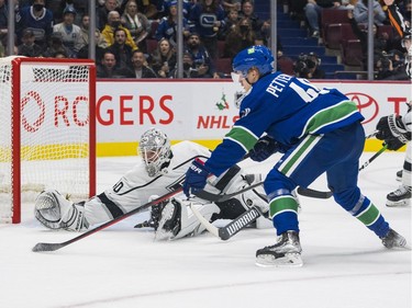 Los Angeles Kings goalie Cal Petersen (40) reaches out to make a save as Vancouver Canucks forward Elias Pettersson (40) handles the loose puck in the second period at Rogers Arena.