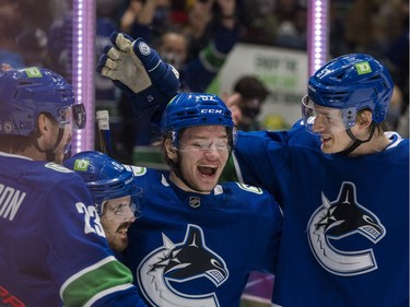 Dec 6, 2021; Vancouver, British Columbia, CAN; Vancouver Canucks defenseman Oliver Ekman-Larsson (23) and forward Conor Garland (8) and forward Vasily Podkolzin (92) and defenseman Tyler Myers (57) celebrate Galrland's goal against the Los Angeles Kings in the second period at Rogers Arena. Mandatory Credit: Bob Frid-USA TODAY Sports