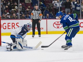 Vancouver Canucks forward Elias Pettersson scores on Winnipeg Jets goalie Eric Comrie during the shootout at Rogers Arena on Friday. Vancouver won 4-3 in a shootout.
