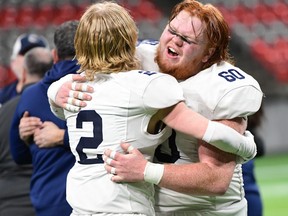 G.W. Graham Grizzlies teammates Theodore Smith (No. 2) and Colton Mocon celebrate their Triple A Coastal win on Saturday, Dec. 4, 2021 at B.C. Place.