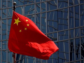 FILE PHOTO: The Chinese national flag is seen in Beijing, China April 29, 2020. REUTERS/Thomas Peter//File Photo