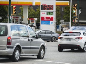 Motorists at Main Street and East 2nd Avenue pass a gas station.