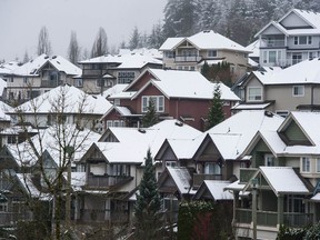 Homes are covered in snow in Port Moody, Saturday, Dec. 4, 2021 after the first snowfall of the year.