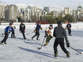 Skaters play a pickup game of shinny during the winter conditions at Vanier Park in Vancouver on Tuesday.