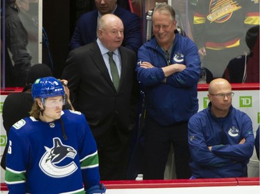 New Vancouver Canucks head coach Bruce Boudreau chats with Equipment Manager Pat O'Neill during pre-game skate as he leads is his team against the L.A. Kings at Rogers Arena in Vancouver, BC. Dec. 6, 2021.