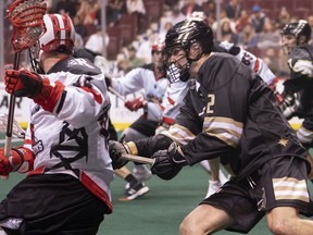 Then-Vancouver Warriors defender Matt Beers (right) lays the lumber on Calgary Roughneck Dane Dobbie during a 2018-19 NLL game at Rogers Arena. ‘I’m sure there will be some nerves leading up to everything,’ Beers says of returning to Rogers Arena with the Saskatchewan Rush.