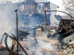 A man looks over the remains of his parents' home damaged by the Marshall Fire in Louisville, Colorado, U.S. December 31, 2021.