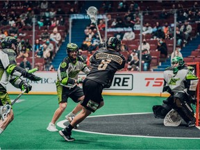 Vancouver's Adam Charalambides gets a shot on Saskatchewan netminder Adam Shute with Rush defenders Holden Garlent (No. 70) and Ryan Dilks (No. 24) in hot pursuit during the Warrior's season opener at Rogers Arena on Dec. 17, 2021.