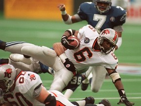 B.C. Lions Cory Philpot is taken down by Baltimore 's Matt Goodwin during the Grey Cup.