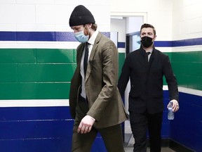 Thatcher Demko #35 (L) and Tanner Pearson #70 of the Vancouver Canucks walk to the Canucks dressing room before their NHL game against the Montreal Canadiens at Rogers Arena on March 10, 2021 in Vancouver.