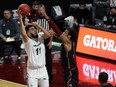 Utah Valley’s Fardaws Aimaq, taking a shot over a New Mexico State defender last season, spent last summer fine-tuning his body, taking what he says was a 18-per-cent body fat figure down to eight per cent.