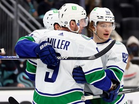 Vasily Podkolzin #92 of the Vancouver Canucks celebrates with his teammates after his goal against the Seattle Kraken during the first period at Climate Pledge Arena on January 01, 2022 in Seattle, Washington.