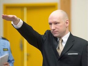 Norwegian mass killer Anders Behring Breivik makes a Nazi salute as he arrives to a makeshift court in Skien prisons gym on March 15, 2016 in Skien, some 130 km south west of Oslo.
