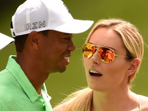 In this April 8, 2015 file photo, golfer Tiger Woods speaks with Lindsey Vonn during the Par 3 competition at Augusta National Golf Club in Augusta, Georgia.
