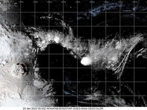 A white plume rises over Tonga when the underwater volcano Hunga Tonga-Hunga Ha'apai erupted, in this still image obtained from an animated GIF from the Cooperative Institute for Research in the Atmosphere (CIRA) and NOAA, January 15, 2021.