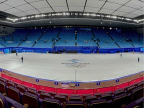 Workers prepare the ice at the Capital Indoor Stadium ahead of the Beijing 2022 Winter Olympic Games in Beijing on January 12, 2022.