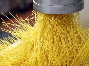 Rejected strands of spaghetti fall from a chute inside Barilla Holding SpA's pasta factory in Parma, Italy, on Wednesday, Oct. 3, 2012.