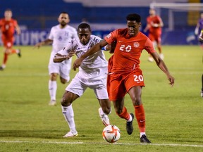 Canada's Jonathan David, right, vies for the ball with Honduras's Maynor Figueroa during their FIFA World Cup Qatar 2022 CONCACAF qualifier at Olimpico Metropolitano Stadium in San Pedro Sula, Honduras, on Jan. 27.