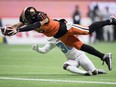 B.C. Lions' Bryan Burnham (16) dives across the goal line to score a touchdown in front of Toronto Argonauts' Trumaine Washington, back, after making a reception during first half CFL football action in Vancouver, Saturday, Oct. 5, 2019.