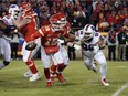 Kansas City Chiefs quarterback Patrick Mahomes (15) scrambles under pressure from Buffalo Bills defensive tackle Star Lotulelei (98) during the second half of the AFC Divisional playoff football game at GEHA Field at Arrowhead Stadium.