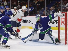 Florida Panthers' Sam Reinhart (13) has his shot deflect off the post behind Vancouver Canucks goalie Spencer Martin and stay out of the goal during the first period of an NHL game in Vancouver on Jan. 21.