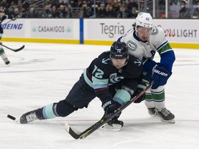 Quinn Hughes (right), leaning on Seattle Kraken winger Joonas Donskoi during last Saturday’s game in Seattle, has focused on his defensive play since last off-season. ‘The majority of it is just a mindset, not wanting people to score on you, defending hard and not making it easy,’ he says.