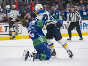 St. Louis Blues defenceman Torey Krug (47) tackles Vancouver Canucks forward Matthew Highmore (15) in the first period at Rogers Arena.