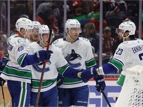 Vancouver Canucks center Elias Pettersson (40) celebrates with teammates after scoring a goal against the Washington Capitals during the second period at Capital One Arena.