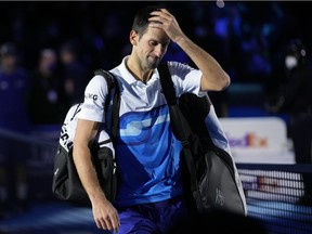 Novak Djokovic of Serbia leaves the court after losing to Alexander Zverev of Germany in their ATP World Tour Finals, singles semifinal, tennis match, at the Pala Alpitour in Turin, Italy, Saturday, Nov. 20, 2021.