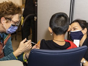 Penny, a nurse at Fraser Health, administers a vaccine shot to a child at a COVID-19 clinic at the Port Coquitlam Community Centre on Jan. 13, 2021.