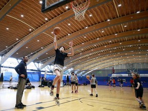 Pasha Bains, co-founder DRIVE sports club, watches his students do layups January 27 at the Richmond oval in Richmond.