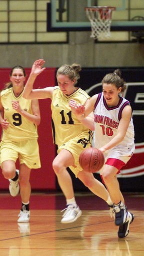 Point guard Danielle Langford (right) pushes the ball up court for Simon Fraser University during a February 2002 Canadian Interuniversity Sports basketball game against the University of B.C.