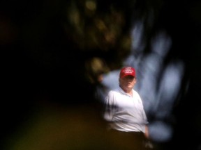 Former U.S. President Donald Trump looks on at the Trump International Golf Club in West Palm Beach, Florida, February 8, 2021.