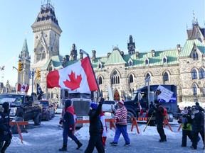 Protesters against the COVID vaccine mandates implemented by Prime Minister Justin Trudeau walk near Parliament Hill on the weekend.