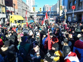 Protesters take in the atmosphere as they dance on the corner of Sussex Drive and Rideau Street on Feb. 5.