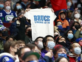 A Canucks fan gets behind new head coach Bruce Boudreau and his club during a December game at Rogers Arena. Boudreau says it will be ‘awesome’ to have the rink at full capacity again on Saturday when the Anaheim Ducks come calling.