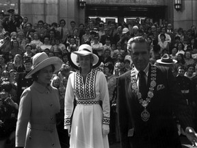 Five thousand well-wishers greeted Queen Elizabeth (left), at Vancouver City Hall as part of her B.C. Centennial year royal visit. At right is Vancouver Mayor Tom Campbell
