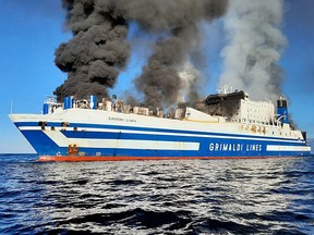Smoke rises from the Italian-flagged Grimaldi Euroferry Olympia that caught fire off the coast of Corfu island, Greece, February 18, 2022, in this picture obtained from social media.