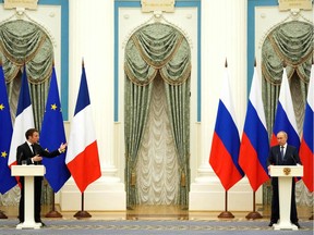 Russian President Vladimir Putin, right, listens during a joint news conference with French President Emmanuel Macron in Moscow, on Feb. 7. International efforts to defuse the standoff over Ukraine intensified with Macron holding talks in Moscow and German Chancellor Olaf Scholz in Washington, D.C., to co-ordinate policies as fears of a Russian invasion mount.