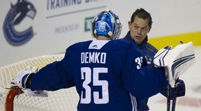Vancouver Canucks goalie coach Ian Clark talks with Thatcher Demko at training camp in Victoria in 2019.