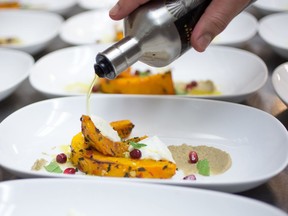 A chef plates food for diners during an earlier Dine Out Vancouver festival.