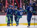 Vancouver Canucks' Luke Schenn, from left to right, Elias Pettersson, Vasily Podkolzin, Nils Hoglander and Tyler Myers celebrate Pettersson's goal against the Arizona Coyotes during the second period of an NHL hockey game in Vancouver, on Tuesday, February 8, 2022.