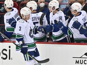 File photo: Vancouver Canucks defenceman Jack Rathbone (3) celebrates a goal against the Seattle Kraken in the first period during a preseason ice hockey game at Spokane Veterans Memorial Arena.