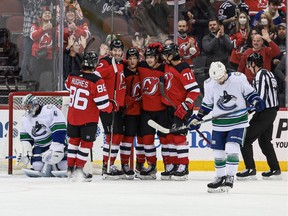 New Jersey Devils center Yegor Sharangovich (17) celebrates his goal with teammates past Vancouver Canucks goaltender Jaroslav Halak (41) during the first period at Prudential Center.