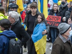 Serhii Yarovyi and his wife Anna Ivasyshyna with hundreds of other people who filled the lawn of the Vancouver Art Gallery Saturday, February 26, 2022 to protest the recent invasion of Ukraine by Russia.